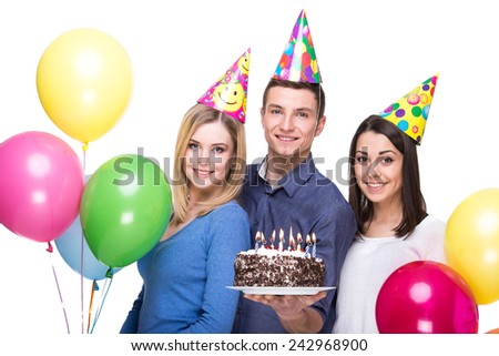 Three young friends having fun on birthday party. White background.