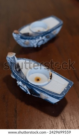 Vertical image of two boats decorations on a dark wood background