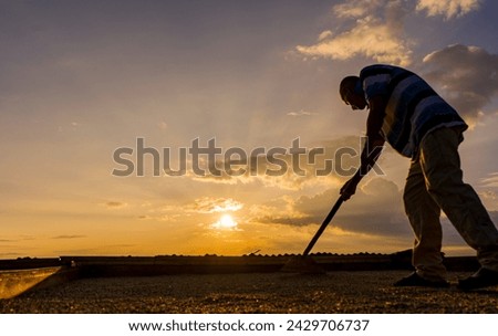 portrait of a farmer working in the open air with a sunset in the background