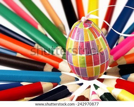 Wooden crayons and Easter egg. The visible spectrum of colors. Arranged in a circle.                                                                       