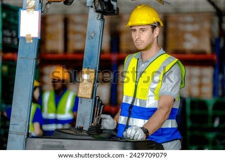 factory man driving forklift car working in distribution warehouse. factory worker teammates working beside stacks of cargo. Group of Diversity engineer factory people meeting. Royalty-Free Stock Photo #2429709079
