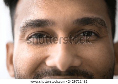 Close up front view face of happy millennial Indian brown-eyed man having attractive appearance optimistic mood, smile, looking at camera, advertising eye-care, vision correction, eyeglasses and lens Royalty-Free Stock Photo #2429711481