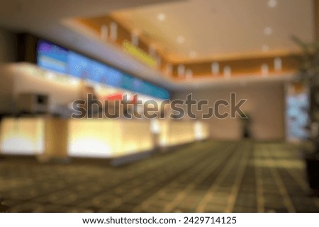 Blurred empty open space lobby cinema. Abstract light bokeh in cinema lobby interior background for design. Royalty-Free Stock Photo #2429714125