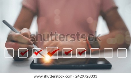 Checklist concept. Businesswoman using a laptop. Checking marks on checkboxes on the futuristic virtual interface screen	