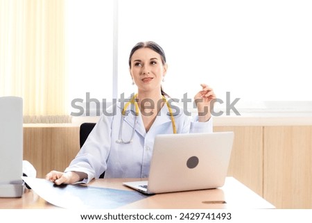 Doctor women working and checking disease examination results on laptop at desk in front hospital.  Young female medical in working room