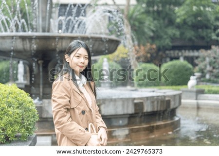 Taiwanese woman in her 20s spending time in a park in Songshan Wenso Park, Xinyi District, Taipei City, Taiwan