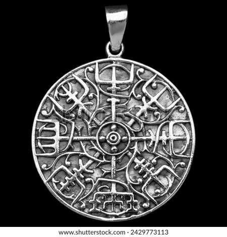 Silver pendant. Helmet of horror. Runic compass, futhark, runes, ravens and wolves of Odin. Viking style. Nordic tradition. Amulet. Valknut. Drakkar. Asatru Valhalla and Asgard. Royalty-Free Stock Photo #2429773113