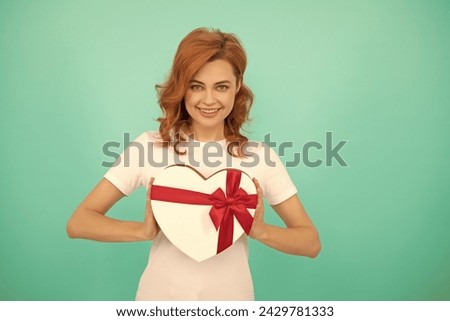happy woman hold heart present box on blue background