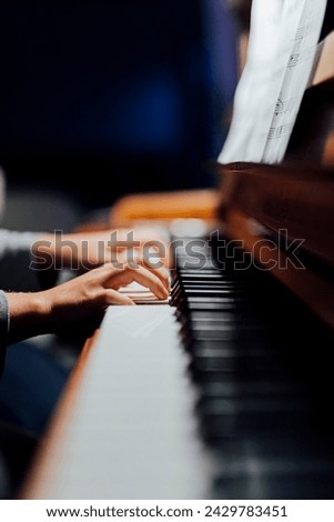 piano player in beutiful light you can only see players hands that is practicing piano lesson.