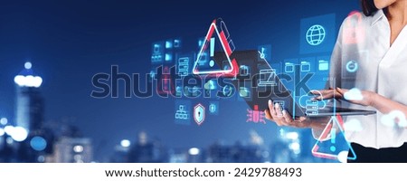 Woman using laptop, big data security hologram, warning and padlock signs, blurred city skyline overlay. Digital folders with files, cloud storage and transfer. Concept of cybersecurity