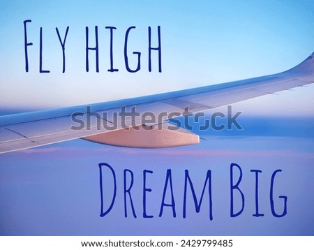 Fly high dream big quote background. Closeup of airplane flying at sunrise and text
