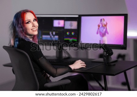 Smiling professional creative digital artist editing video at work in minimalistic office space