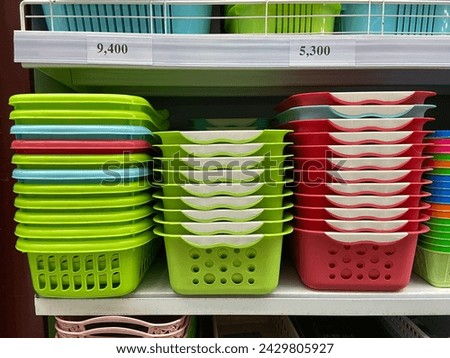 plastic baskets of various colors on a supermarket display shelf
