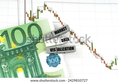 Business concept. On the quote chart there are euros and clothespins with the inscription - Market Data Visualization