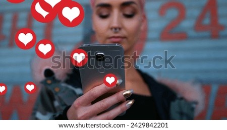 Image of falling social media icons over women using smartphone. social media and communication concept digitally generated image.