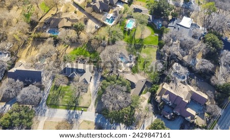 Aerial view upscale two story house with circular driveway, swimming pool, large backyard, suburban low density housing small number residential single family homes, expensive area Dallas, Texas. USA Royalty-Free Stock Photo #2429847161