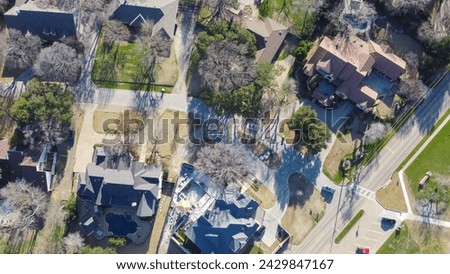 Aerial view upscale two story house with circular driveway, swimming pool, large backyard, suburban low density housing small number residential single family homes, expensive area Dallas, Texas. USA