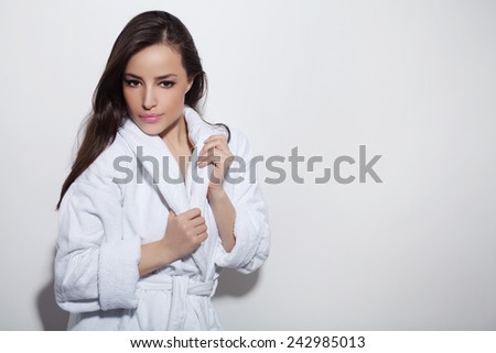beautiful woman wearing white bathrobe, studio white