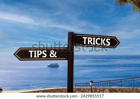 Tips and tricks symbol. Concept word Tips and tricks on beautiful signpost with two arrows. Beautiful blue sea sky with clouds background. Business and Tips and tricks concept. Copy space. Royalty-Free Stock Photo #2429855517