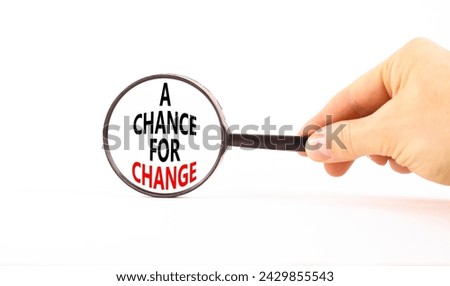 A chance for change symbol. Concept words A chance for change on beautiful magnifying glass. Beautiful white table white background. Voter hand. Business A chance for change concept. Copy space.