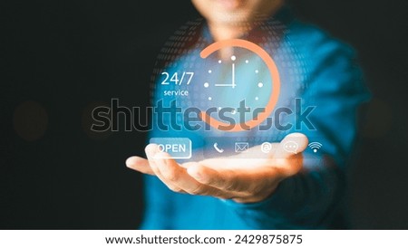 Nonstop service contact us concept. Businessman hand holding virtual 24-7 with clock on hand nonstop and full-time available contact of service, customer service agents Royalty-Free Stock Photo #2429875875