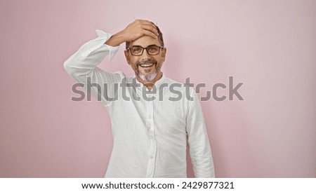 Young hispanic grey-haired man standing with surprise expression over isolated pink background