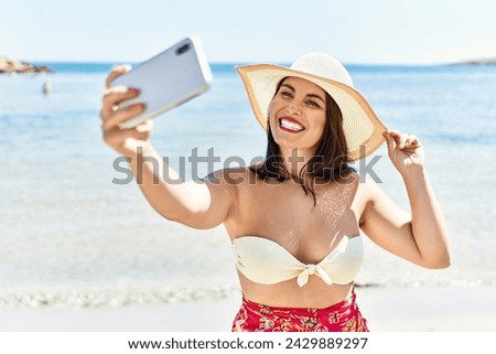 Young beautiful hispanic woman tourist smiling confident make slefie by smartphone at seaside