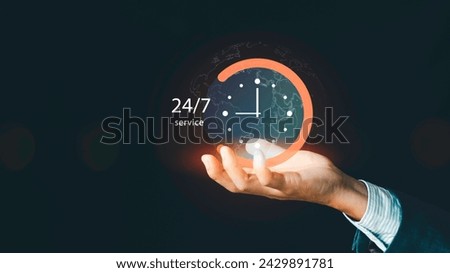 Nonstop service contact us concept. Businessman hand holding virtual 24-7 with clock on hand nonstop and full-time available contact of service, customer service agents Royalty-Free Stock Photo #2429891781