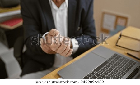 Senior man's painful wrist at work, a business worker nursing injured hand while working at office desk, indoors