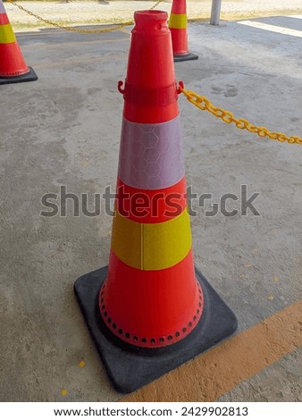 orange traffic cone on store parking lot