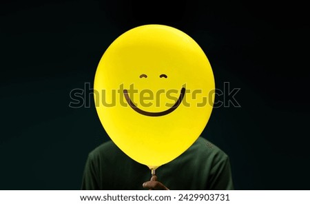 Happiness Day Concept. Happy and Optimistic Mind, Well Mental Health. Enjoying Life Everyday. Happiness Person with a Smiling Emoticon Balloon