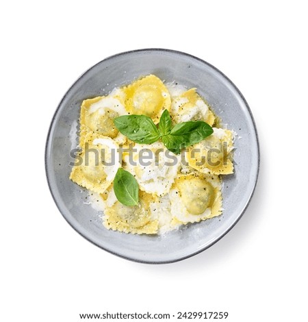 Homemade Ravioli pasta with spinach and ricotta cheese filling with creamy white sauce and grated Parmesan cheese. top view. isolated on white background Royalty-Free Stock Photo #2429917259