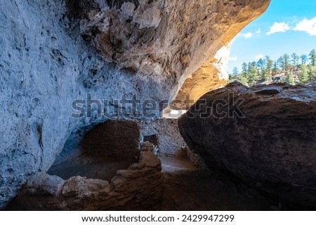 Walking inside Gila Cliff Dwellings caves. New Mexico, USA. Royalty-Free Stock Photo #2429947299