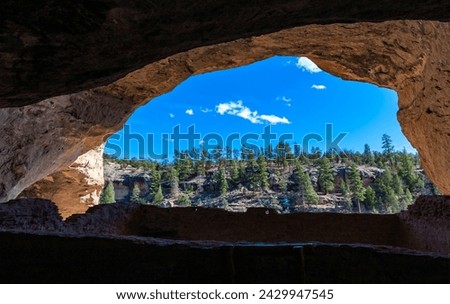 View on canyon with pine trees and beautiful blue sky on background from the cave arch  inside Gila Cliff Dwellings. New Mexico, USA. Royalty-Free Stock Photo #2429947545