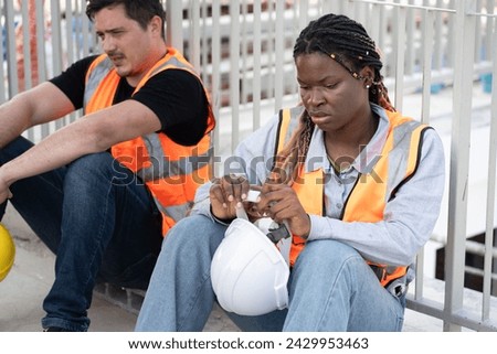 Portrait very tired worker caucasian or engineer man and African woman at construction site