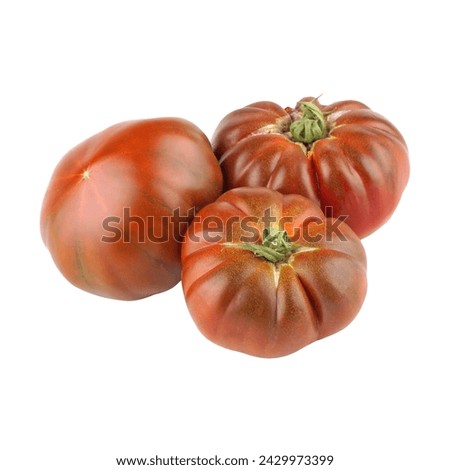 Three heirloom chocolate tomatoes with a unique brownish-red color, featuring deep ridges and a slightly flattened shape, isolated on a white background. Royalty-Free Stock Photo #2429973399
