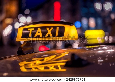 Classic cab sign with the city lights in the background