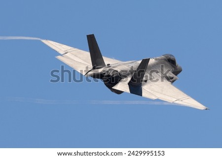 Tail view of a F-35C Lightning II  with trails at the wing  tips  Royalty-Free Stock Photo #2429995153