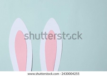 Easter decor concept. Top photo of Easter bunny ears on colored background 