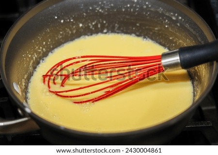 The process of making custard cream filling for pastries.