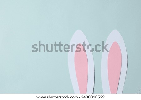 Easter decor concept. Top photo of Easter bunny ears on colored background 
