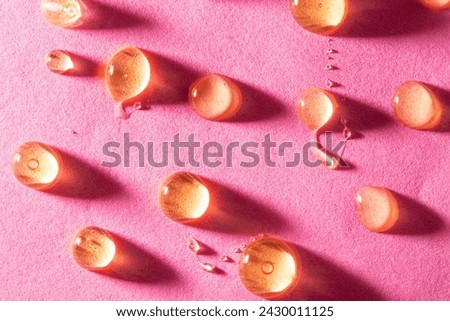 Close up macro shot of drops of honey on a pink background. Flat lay, top view design. Natural, food, energy 3d pattern.