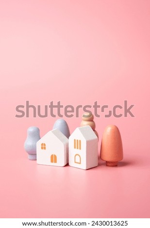 Figures of houses and trees on a pink background. Buy or rent a home. Mortgage and loan. Affordable housing. Buying a nice house.