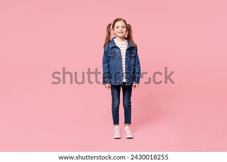 Full body little child smiling cheerful cute kid girl 7-8 years old wears denim shirt have fun look camera isolated on plain pastel light pink background. Mother's Day love family lifestyle concept