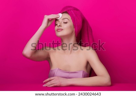 Woman with cotton pad. Toner for cleaning make up. Clean healthy skin, studio background. Beauty woman holding cotton pad, applying cleansing lotion facial wipe on face, removing makeup. Royalty-Free Stock Photo #2430024643