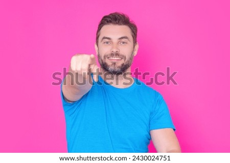 The Index finger. The point you. Happy handsome man pointing finger you away, isolated blue background. Excited man pointing a you great idea. Guy in blue t-shirt pointing you with his finger.