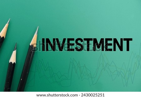 Word text Investment memo written on a green board as background with black pencils and graph