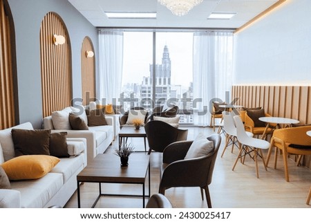 Empty stylish and modern office interior with skyscrapers view decorated with table, chair, botany decoration, elegant accessory. Living room. Modern interior. Creative design. Day light. Ornamented. Royalty-Free Stock Photo #2430025417