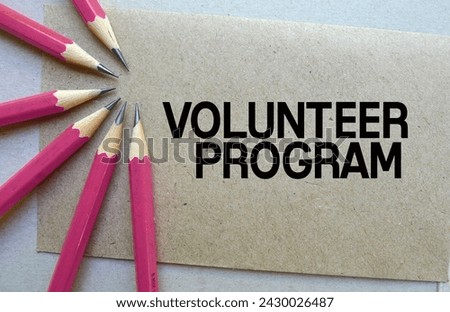 Word text Volunteer Program memo written on a brown craft paper as background with pink pencils Royalty-Free Stock Photo #2430026487