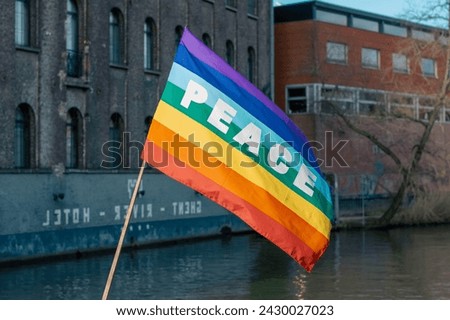 rainbow colored flag with peace written on it. world peace and no war movements. Rainbow coloured flag Moving gently in the wind